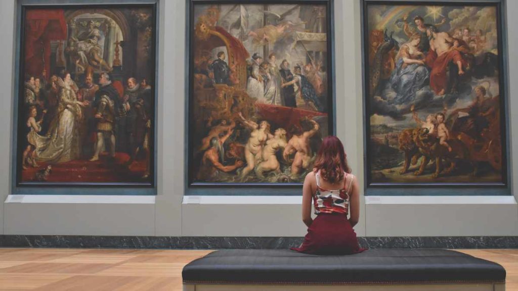 a woman watching paintings