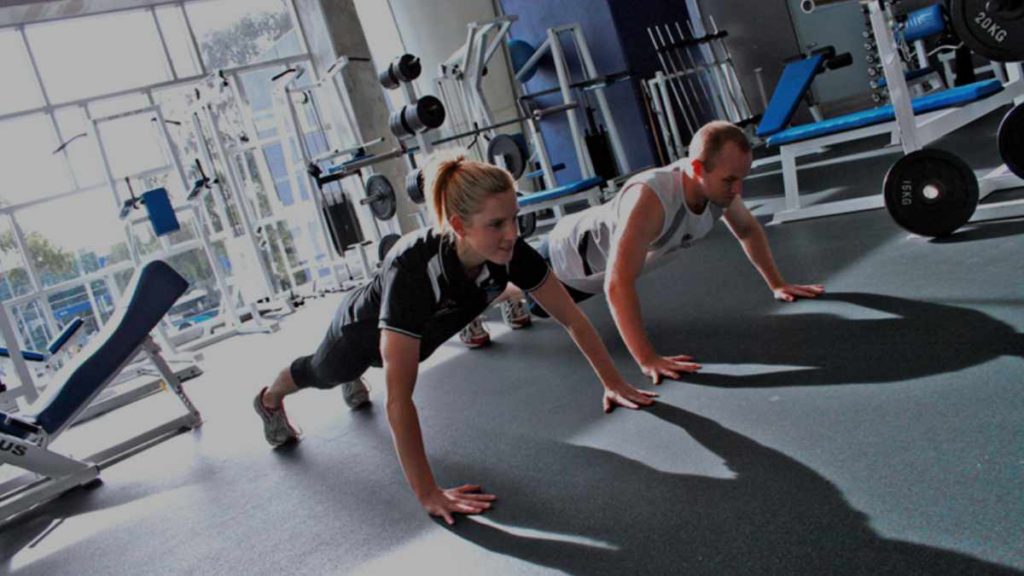 a man and a woman doing push-ups